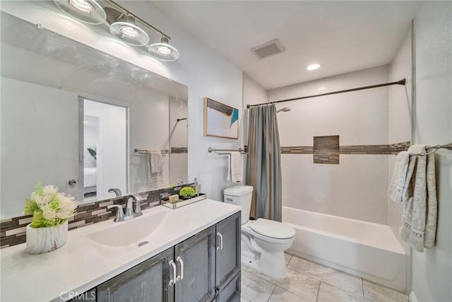 bathroom with vanity, toilet, visible vents, and shower / bath combo with shower curtain