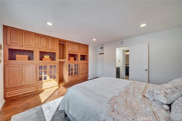 bedroom featuring recessed lighting and wood finished floors