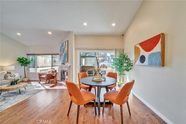 dining room featuring a wealth of natural light, baseboards, and wood finished floors