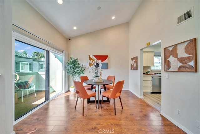 dining space with visible vents, baseboards, a healthy amount of sunlight, and wood finished floors