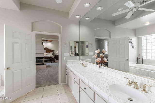 full bathroom with tile patterned flooring, double vanity, ceiling fan, and a sink