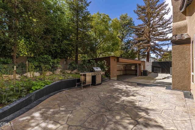 view of patio / terrace with cooling unit, a fenced backyard, and a grill