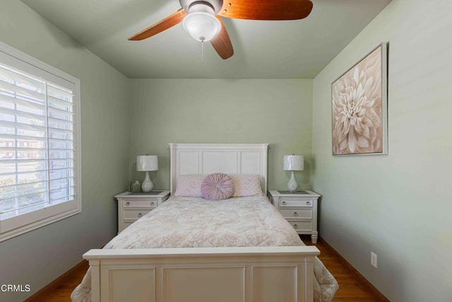 bedroom with ceiling fan and baseboards