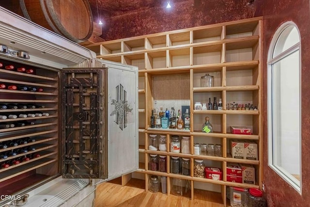 wine area featuring beverage cooler and wood finished floors