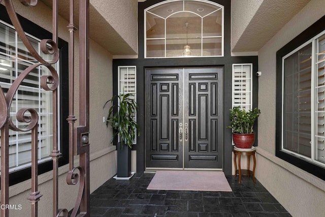 entrance to property featuring stucco siding