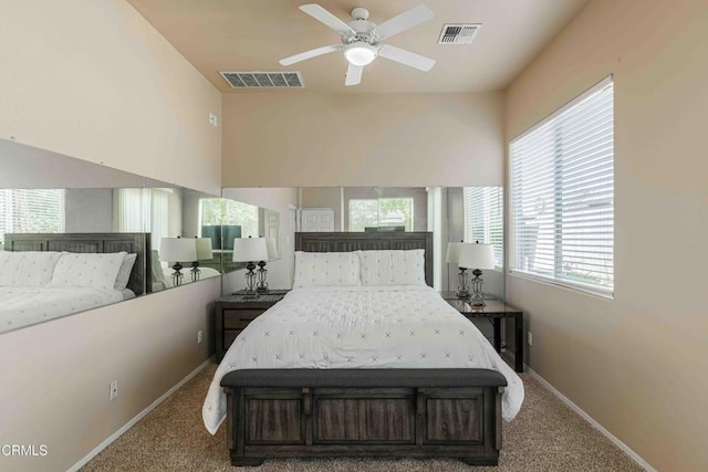 bedroom with visible vents, carpet flooring, lofted ceiling, and baseboards