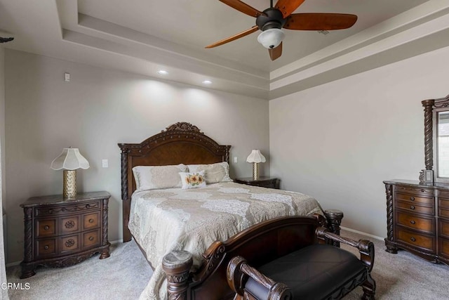 bedroom featuring a tray ceiling, recessed lighting, carpet flooring, baseboards, and ceiling fan