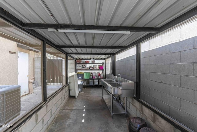 exterior space with concrete block wall and concrete floors