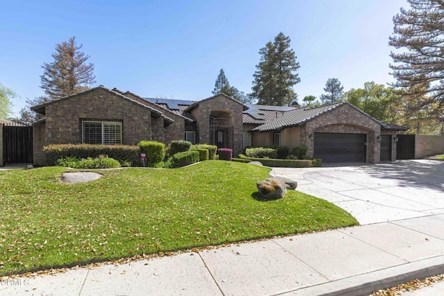 single story home featuring concrete driveway, a garage, stone siding, and a front lawn