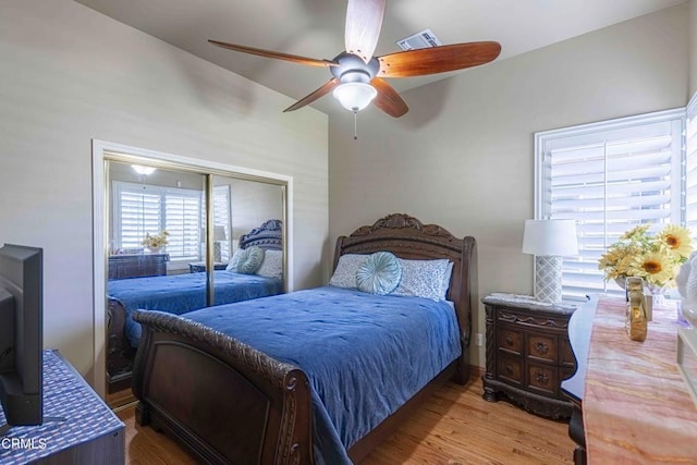 bedroom featuring a closet, visible vents, ceiling fan, and wood finished floors