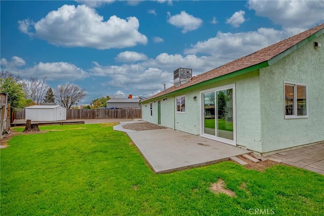 view of yard with a storage unit, a patio, an outdoor structure, and a fenced backyard