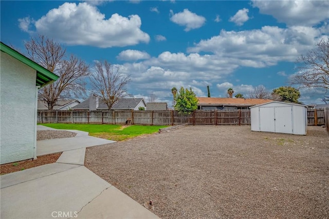 view of yard with a storage unit, a patio area, an outdoor structure, and a fenced backyard