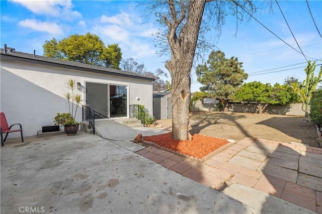 exterior space with a storage shed, a fenced backyard, and an outdoor structure