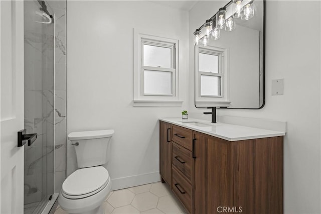 full bathroom with a stall shower, toilet, vanity, and baseboards