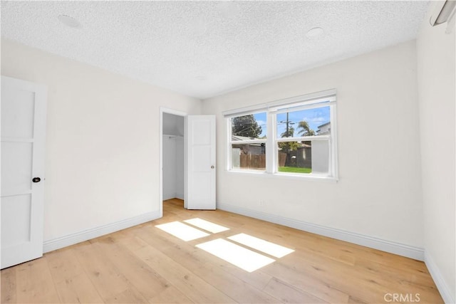 unfurnished bedroom featuring light wood-style flooring and baseboards