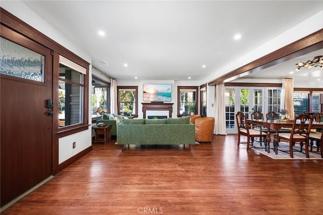 living area with wood finished floors, french doors, and a wealth of natural light