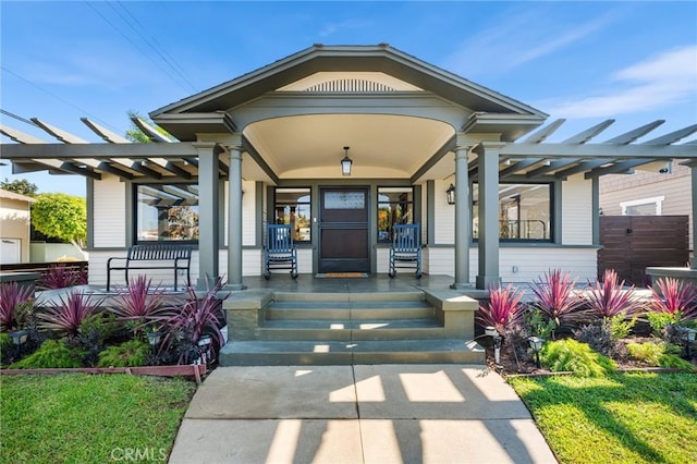 property entrance featuring a porch and a pergola