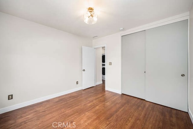 274 Grand Ave, Long Beach, CA 90803 - unfurnished bedroom with wood finished floors, a closet, and baseboards