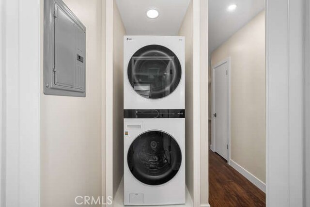 274 Grand Ave, Long Beach, CA 90803 - laundry room with stacked washer / drying machine, dark wood finished floors, electric panel, baseboards, and recessed lighting