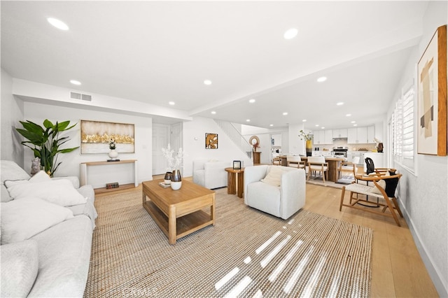 living room featuring stairs, recessed lighting, and visible vents