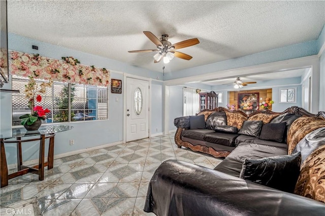 6324 Denver Ave, Los Angeles, CA 90044 - living room featuring tile patterned flooring, a textured ceiling, baseboards, and a ceiling fan