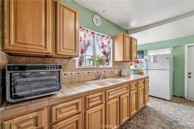 6324 Denver Ave, Los Angeles, CA 90044 - kitchen featuring a sink, freestanding refrigerator, a toaster, decorative backsplash, and tile counters