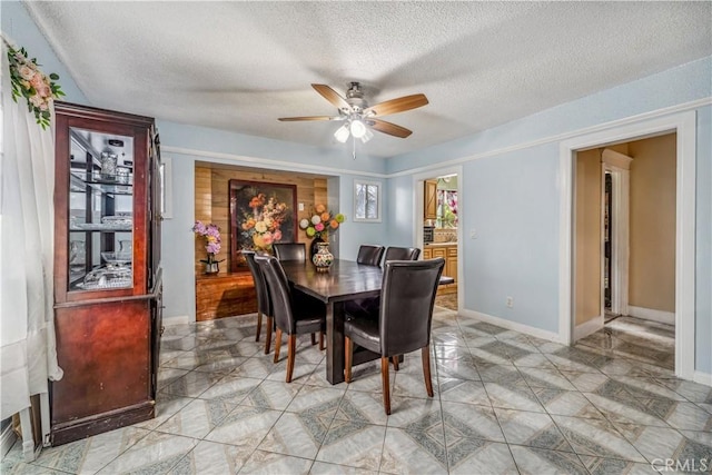 6324 Denver Ave, Los Angeles, CA 90044 - dining room with baseboards, ceiling fan, and a textured ceiling