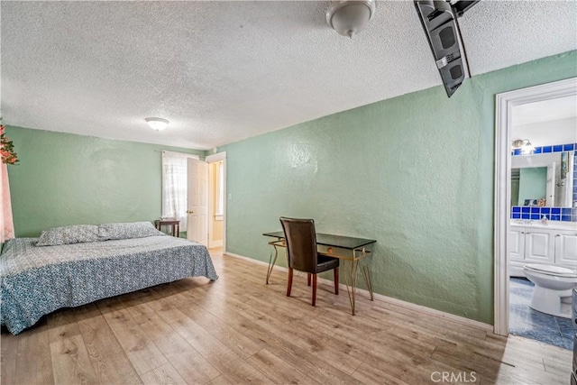 6324 Denver Ave, Los Angeles, CA 90044 - bedroom with a textured ceiling, ensuite bathroom, wood finished floors, and a textured wall