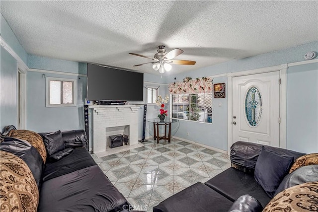 6324 Denver Ave, Los Angeles, CA 90044 - living room featuring a textured ceiling, light tile patterned floors, baseboards, ceiling fan, and a brick fireplace