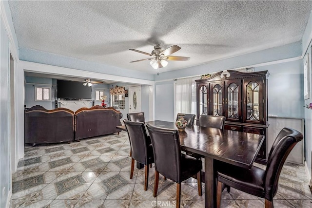 6324 Denver Ave, Los Angeles, CA 90044 - dining room featuring light floors, a textured ceiling, and a ceiling fan