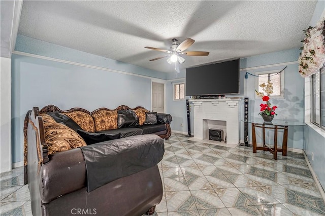 6324 Denver Ave, Los Angeles, CA 90044 - living area with baseboards, a fireplace with flush hearth, ceiling fan, and a textured ceiling