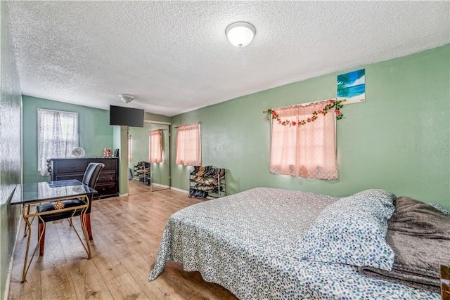 6324 Denver Ave, Los Angeles, CA 90044 - bedroom with a textured ceiling and wood finished floors