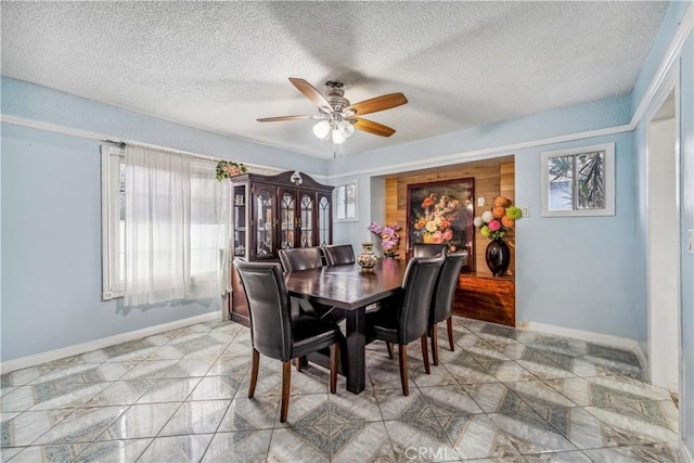 6324 Denver Ave, Los Angeles, CA 90044 - dining space with a textured ceiling, baseboards, a ceiling fan, and marble finish floor