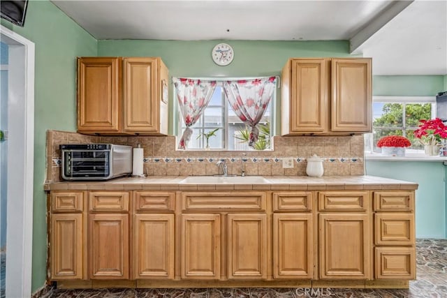 6324 Denver Ave, Los Angeles, CA 90044 - kitchen featuring backsplash, tile counters, a toaster, and a sink