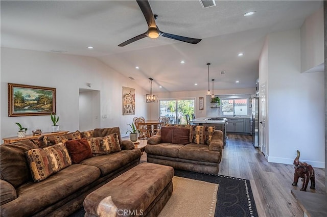 living room with a ceiling fan, visible vents, baseboards, recessed lighting, and dark wood-style flooring