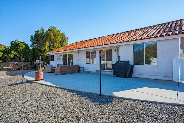 back of house featuring fence, stucco siding, outdoor lounge area, a tile roof, and a patio area