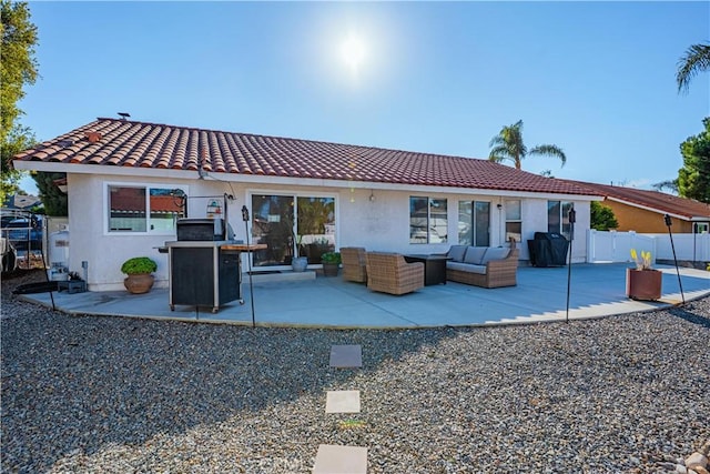 back of property featuring a patio, fence, an outdoor living space, and stucco siding