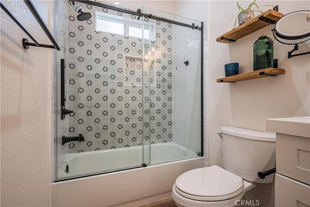 full bathroom with toilet and shower / bath combination with glass door