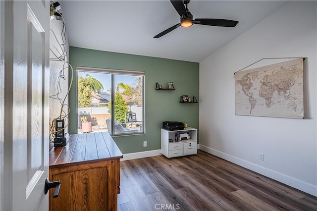 unfurnished office featuring baseboards, dark wood-type flooring, and a ceiling fan