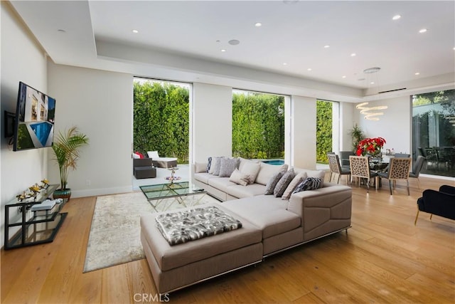 living area featuring light wood finished floors, recessed lighting, and baseboards