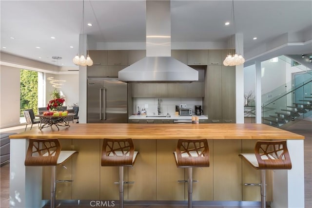 kitchen with stainless steel built in fridge, a notable chandelier, and butcher block countertops