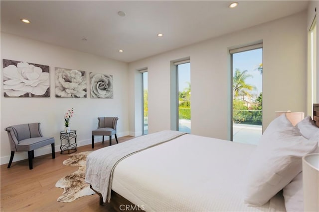 bedroom with recessed lighting, baseboards, and light wood-style floors