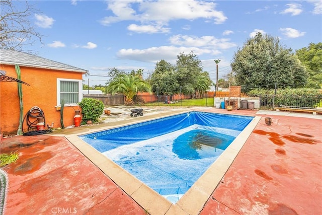 view of swimming pool with a fenced in pool, a patio, and a fenced backyard