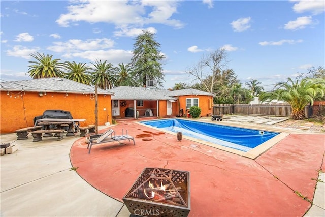 view of swimming pool featuring a patio area, a fenced in pool, and fence