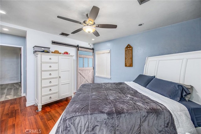 bedroom featuring visible vents, ceiling fan, a barn door, recessed lighting, and dark wood-style floors