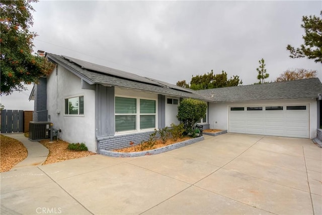 view of front of property with an attached garage, stucco siding, driveway, a shingled roof, and cooling unit