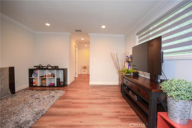 hallway with baseboards, visible vents, wood finished floors, and crown molding
