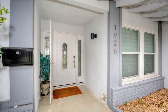 property entrance with stucco siding