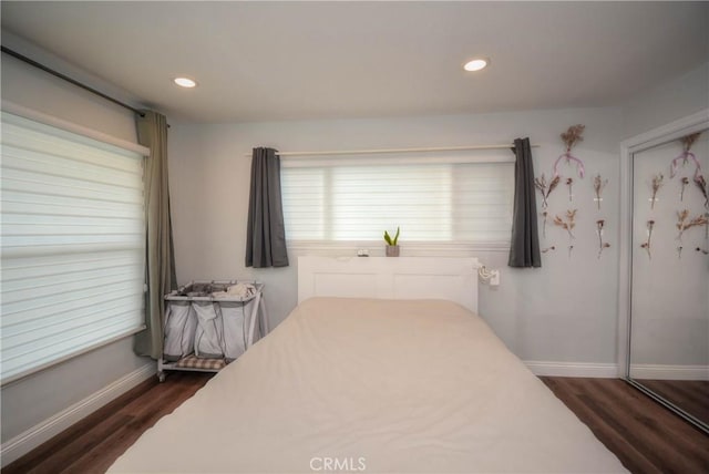 bedroom featuring baseboards, dark wood-style floors, and recessed lighting
