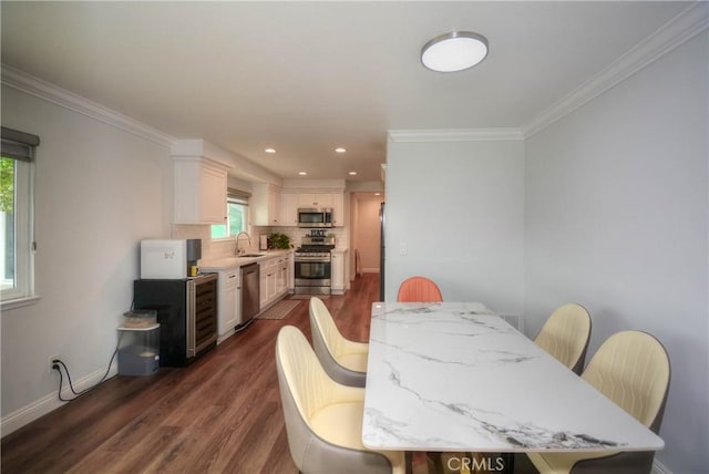 dining space with recessed lighting, dark wood-type flooring, baseboards, and crown molding
